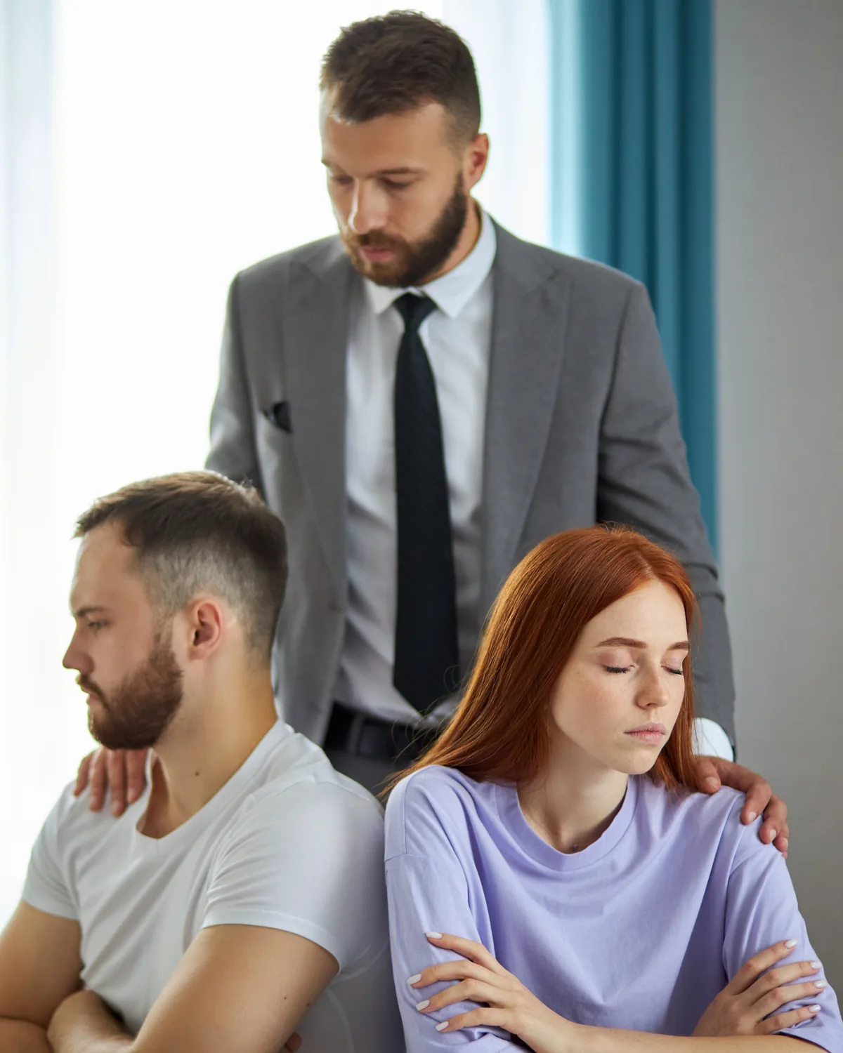 A mediator listening to a couple during a session.